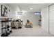 Finished basement with carpet flooring, comfortable seating, and a black bar cart at 3928 Zuni St, Denver, CO 80211