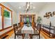 Bright dining room boasts modern lighting, stylish decor, and a clear view to other rooms through a wooden partition at 3928 Zuni St, Denver, CO 80211