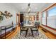 Bright dining room with contemporary lighting, wooden floors, and an open layout to kitchen at 3928 Zuni St, Denver, CO 80211