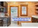 A shot of the kitchen featuring brick wall and modern dark cabinets at 3928 Zuni St, Denver, CO 80211