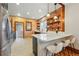 Exposed brick accent wall and black and white tile flooring offer a modern contrast to stainless appliances in this open kitchen at 3928 Zuni St, Denver, CO 80211