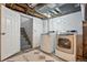 Bright laundry room with modern appliances and access to basement stairs at 3928 Zuni St, Denver, CO 80211