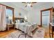 Cozy bedroom featuring a decorative ceiling fan, large window, and an area rug at 3928 Zuni St, Denver, CO 80211