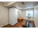 A functional basement space with exercise equipment, a full size refrigerator, and hardwood flooring at 9325 Lark Sparrow Dr, Highlands Ranch, CO 80126
