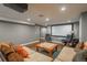 Finished basement with a home theatre featuring a large screen, comfortable seating and hardwood flooring at 9325 Lark Sparrow Dr, Highlands Ranch, CO 80126