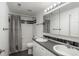 Bathroom featuring double sinks, a large mirror, and a shower and tub combination with black trim at 9325 Lark Sparrow Dr, Highlands Ranch, CO 80126