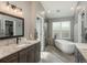 Beautiful bathroom with soaking tub, glass shower, double vanity, and modern fixtures at 9325 Lark Sparrow Dr, Highlands Ranch, CO 80126