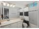 Bathroom with white cabinets, large mirror, a shower and tub combination, and black and white shower curtain at 9325 Lark Sparrow Dr, Highlands Ranch, CO 80126