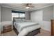 Bedroom featuring paneled wall, ceiling fan, carpeted floor, window with blind, and closet with folding doors at 9325 Lark Sparrow Dr, Highlands Ranch, CO 80126
