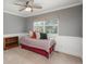 Charming bedroom with neutral paint, wainscoting, a ceiling fan, and a bright window with neutral window covering at 9325 Lark Sparrow Dr, Highlands Ranch, CO 80126