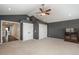 Bedroom featuring two closets with folding doors and doorway to hall on carpeted floor with a ceiling fan at 9325 Lark Sparrow Dr, Highlands Ranch, CO 80126
