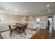 Bonus room with wood floors, round table with chairs, railing, and overhead lighting at 9325 Lark Sparrow Dr, Highlands Ranch, CO 80126
