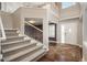 Bright foyer with hardwood floors, a staircase, and a view of the dining room at 9325 Lark Sparrow Dr, Highlands Ranch, CO 80126