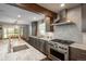 Modern kitchen features stainless steel appliances, stone countertops, and a herringbone tile backsplash at 9325 Lark Sparrow Dr, Highlands Ranch, CO 80126