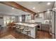 Modern kitchen featuring a large island, stainless steel appliances, and an open layout connecting to the dining area at 9325 Lark Sparrow Dr, Highlands Ranch, CO 80126