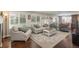 Bright living room with hardwood floors, neutral decor, and large windows overlooking backyard at 9325 Lark Sparrow Dr, Highlands Ranch, CO 80126
