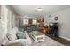 Open-concept living area with hardwood floors, neutral decor, and seamless flow to dining at 9325 Lark Sparrow Dr, Highlands Ranch, CO 80126