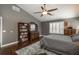 Spacious main bedroom with dark wood floors, area rug, a ceiling fan, and lots of natural light at 9325 Lark Sparrow Dr, Highlands Ranch, CO 80126