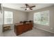 The office features neutral paint, carpeted floors, a ceiling fan, and a large dark wood executive desk at 9325 Lark Sparrow Dr, Highlands Ranch, CO 80126