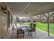 Covered patio with outdoor seating, overlooking a lush backyard with mature trees at 9325 Lark Sparrow Dr, Highlands Ranch, CO 80126