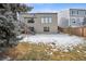 Backyard showcasing the home's exterior with large windows and mature trees at 1711 Spring Water Ln, Highlands Ranch, CO 80129