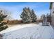 Spacious backyard featuring mature trees, a partial fence, and access stairs to the home at 1711 Spring Water Ln, Highlands Ranch, CO 80129