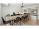 Open dining area with a large wooden table, modern lighting, and hardwood floors at 1711 Spring Water Ln, Highlands Ranch, CO 80129