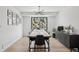 Dining room with modern chandelier, large window, and long wooden table at 1711 Spring Water Ln, Highlands Ranch, CO 80129