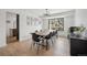 Dining room featuring hardwood floors, a long wooden table, and large windows at 1711 Spring Water Ln, Highlands Ranch, CO 80129