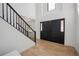 Bright foyer with hardwood floors, a staircase with black railings, and soaring ceilings at 1711 Spring Water Ln, Highlands Ranch, CO 80129