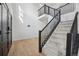 Bright foyer with a staircase featuring black railings and hardwood floors at 1711 Spring Water Ln, Highlands Ranch, CO 80129