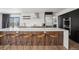 Modern kitchen featuring an island with wooden stools, stainless steel appliances, and hardwood floors at 1711 Spring Water Ln, Highlands Ranch, CO 80129