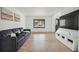 Bright living room with hardwood floors, a comfortable sofa, and a large window at 1711 Spring Water Ln, Highlands Ranch, CO 80129