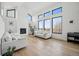 Living room with tall windows, fireplace, and comfortable seating at 1711 Spring Water Ln, Highlands Ranch, CO 80129