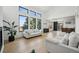 Open-concept living room with large windows, hardwood floors, and bright light at 1711 Spring Water Ln, Highlands Ranch, CO 80129