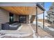 Outdoor patio area with stone flooring and comfortable seating underneath the deck at 1711 Spring Water Ln, Highlands Ranch, CO 80129