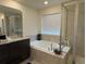 Elegant bathroom with soaking tub, granite vanity, and walk-in shower at 2521 E 163Rd Pl, Thornton, CO 80602