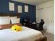 Bedroom with built-in workspace and blue accent wall at 2521 E 163Rd Pl, Thornton, CO 80602