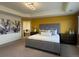 Main bedroom with large bed and en-suite bathroom at 2521 E 163Rd Pl, Thornton, CO 80602