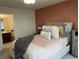 Bedroom with en-suite bathroom and terracotta walls at 2521 E 163Rd Pl, Thornton, CO 80602