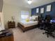 Bedroom with workspace and blue accent wall at 2521 E 163Rd Pl, Thornton, CO 80602