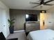 Spacious bedroom with large TV and wall accent at 2521 E 163Rd Pl, Thornton, CO 80602