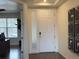 Bright entryway with white door, wood floors, and modern wall art at 2521 E 163Rd Pl, Thornton, CO 80602