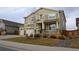Two-story house with beige siding, stone accents, and a three-car garage at 2521 E 163Rd Pl, Thornton, CO 80602