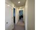 Long hallway connecting multiple rooms at 2521 E 163Rd Pl, Thornton, CO 80602