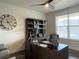 Spacious home office with built-in shelving and large windows at 2521 E 163Rd Pl, Thornton, CO 80602