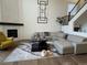 Bright living room with a curved sectional sofa and a fireplace at 2521 E 163Rd Pl, Thornton, CO 80602