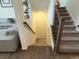 Elegant staircase with dark wood railings and carpeted steps at 2521 E 163Rd Pl, Thornton, CO 80602