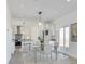Bright dining area with modern lighting, glass table, and sliding door access to the outdoors at 61400 E 56 Ave, Strasburg, CO 80136