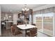 Cozy dining area with wood cabinets, stainless appliances, large sliding door, and modern table set at 61400 E 56 Ave, Strasburg, CO 80136